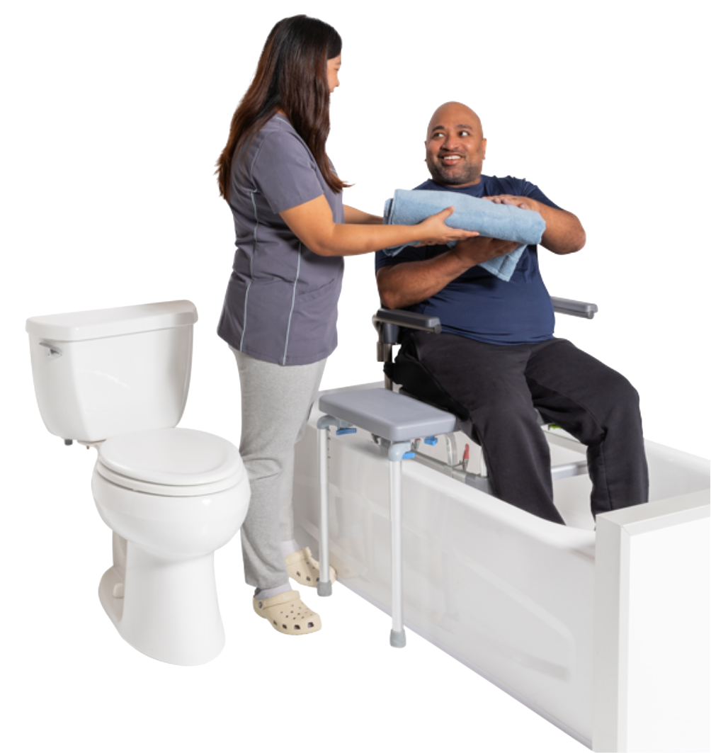 Caregiver assisting a man using the Raze by Raz bath transfer chair, handing him towels beside a toilet