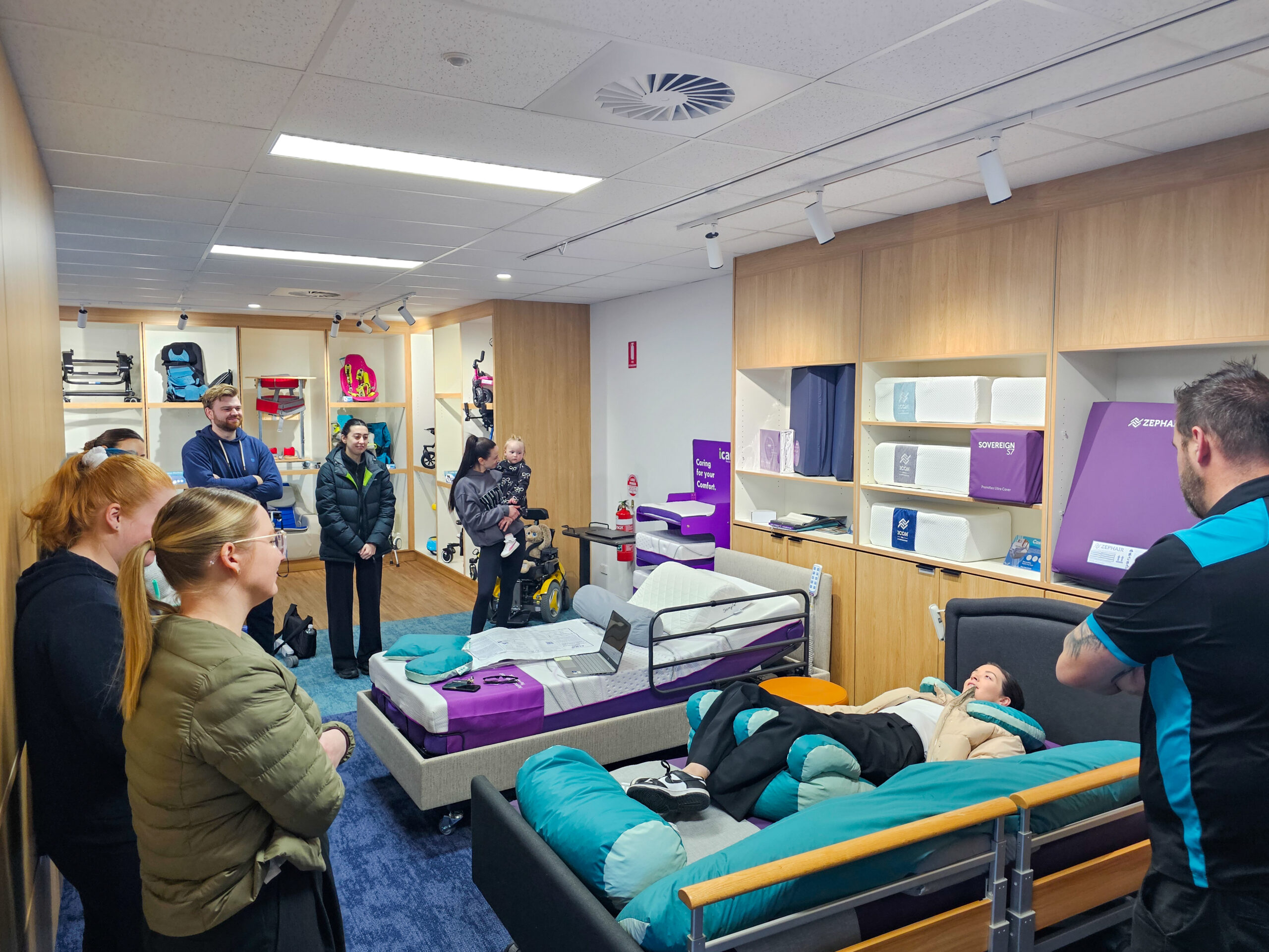 Rehabilitation equipment training session with hospital beds positioning cushions and mobility aids