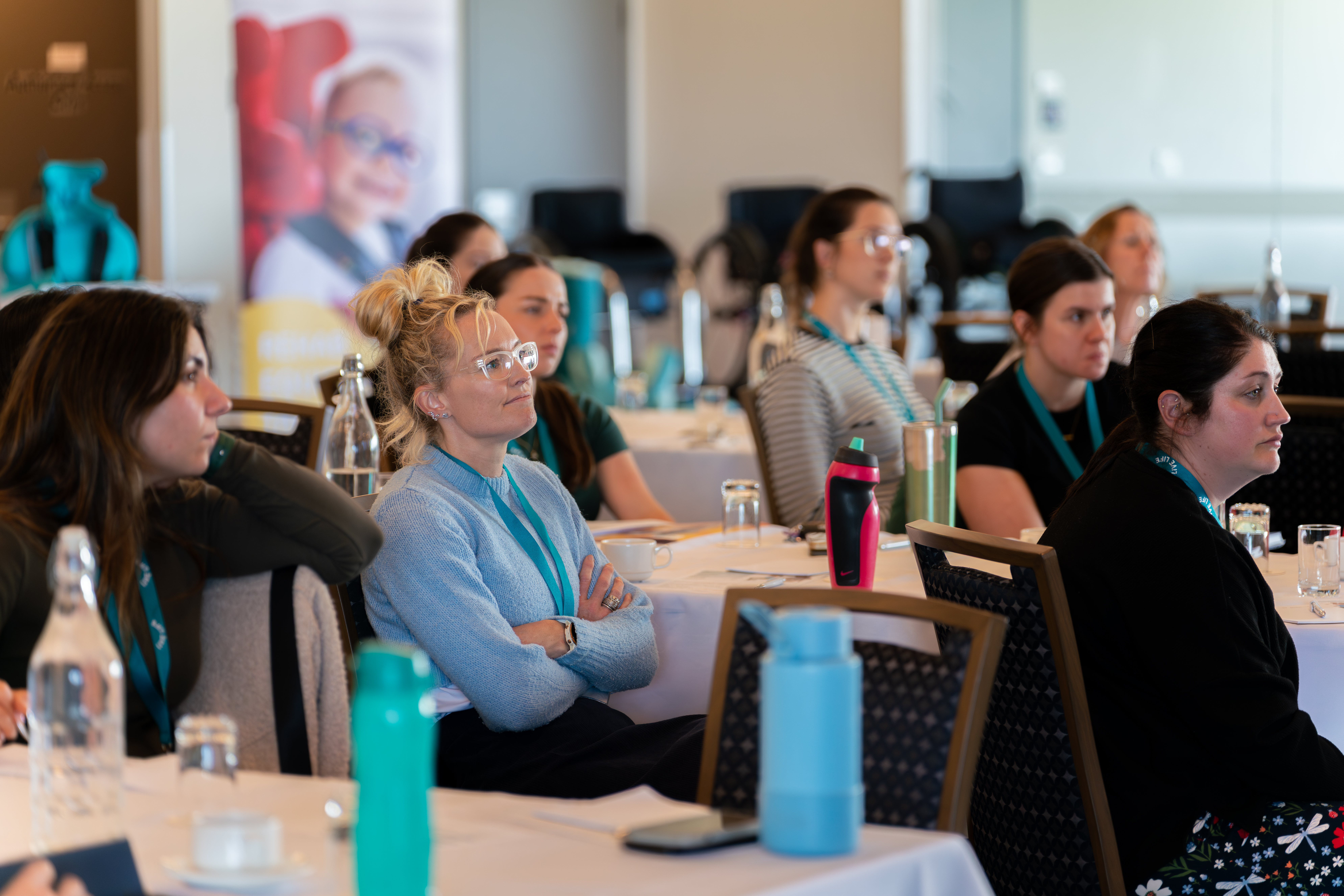 Attendees listening to speaker at professional conference seminar indoors