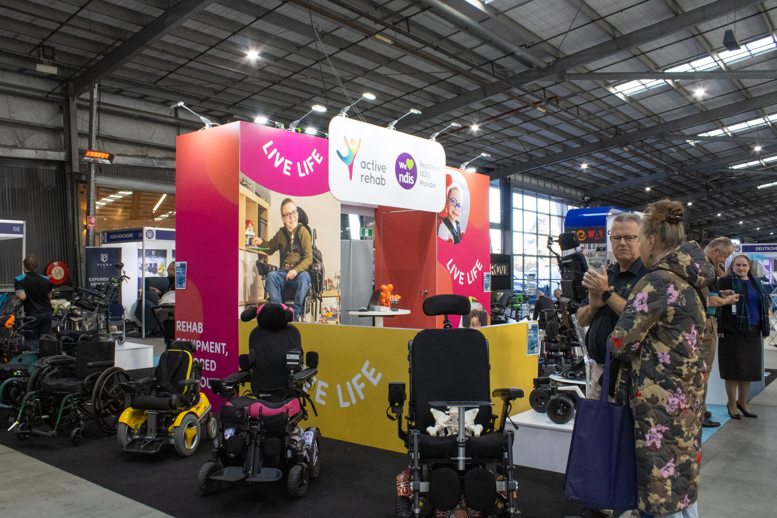 Active Rehab We NDIS exhibition stand with wheelchairs and visitors