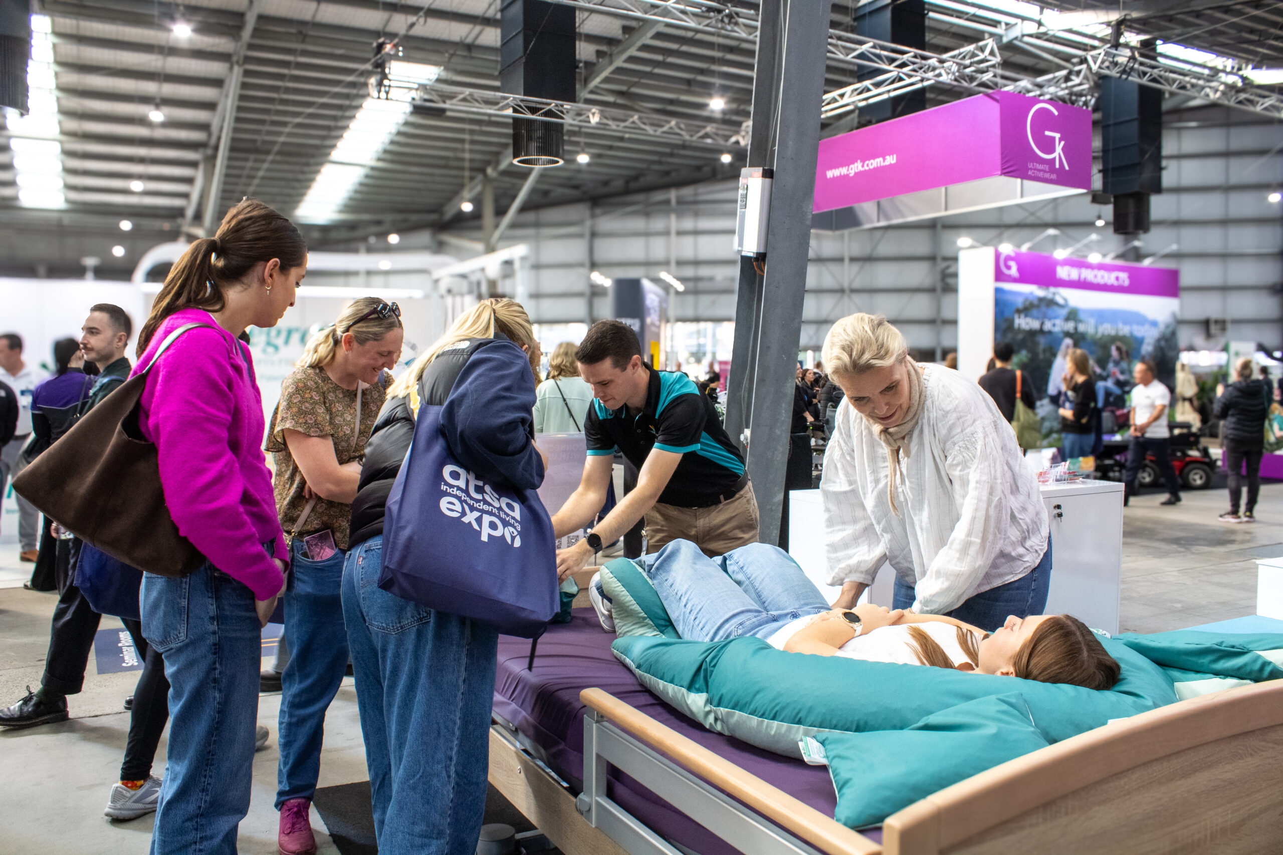 Assistive care demonstration with positioning cushions at healthcare exhibition