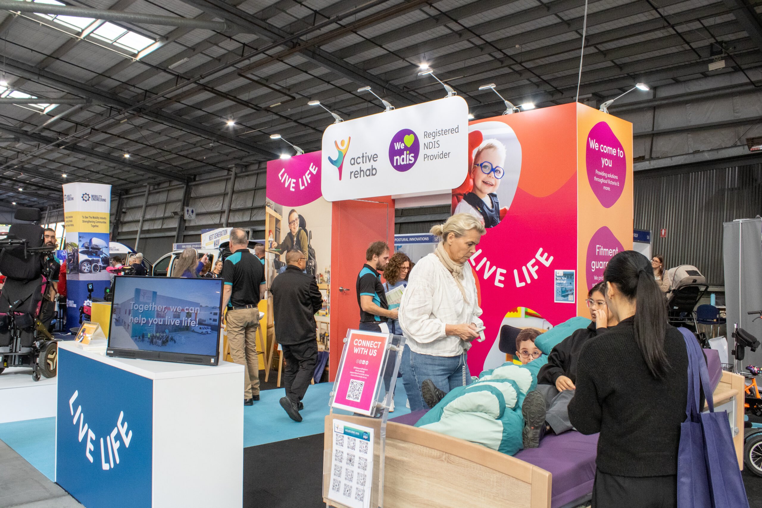 Assistive technology exhibition booth showcasing rehabilitation and mobility solutions